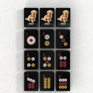The image is a collage of 12 black tiles, each featuring a different number and a dog image. The tiles are arranged in a grid pattern, with each tile containing a unique number and a dog image. The tiles are labeled with the numbers 1 through 9 and the words 'Coco' and 'Coco' written on them.