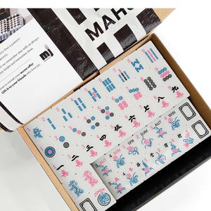 a set of mahjong tiles in an open box, with the text "Mahjong Set Only" visible.