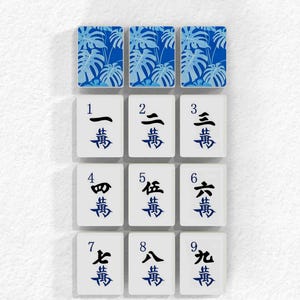 a collection of tiles with various characters and symbols on them, arranged in a grid format.