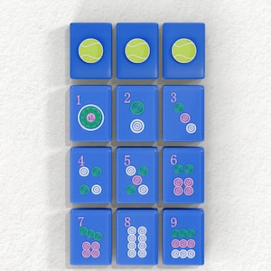 A collection of blue tiles with various designs, including tennis balls and numbers, arranged in a grid pattern.