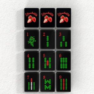 a collection of black tiles with various designs and numbers, arranged in a grid-like pattern.