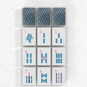a collection of bamboo tiles arranged in a grid pattern, with each tile featuring a unique design and color scheme.