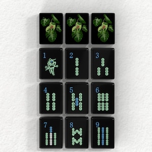 a collection of black tiles with various plant illustrations and numbers on them.