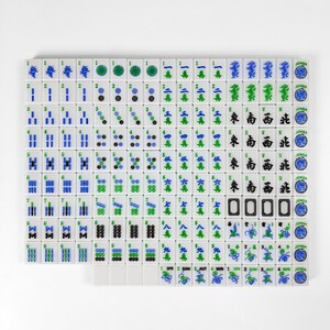 a grid of tiles with various symbols and numbers, including blue and green tiles, as well as tiles with numbers and other geometric shapes.