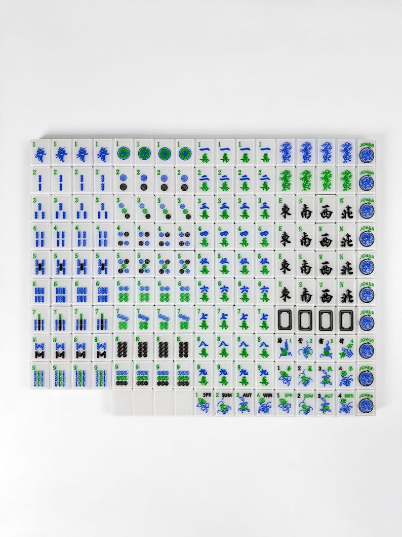 a grid of tiles with various symbols and numbers, including blue and green tiles, as well as tiles with numbers and other geometric shapes.