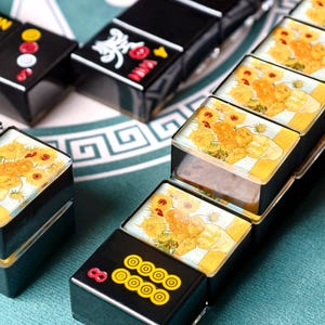 a collection of dominoes with various designs and colors, arranged on a surface.