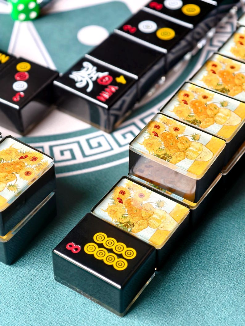 a collection of dominoes with various designs and colors, arranged on a surface.