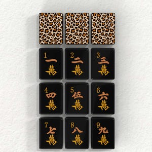 nine tiles, each with a unique leopard print pattern and a number on it. The tiles are arranged in a grid-like pattern, with each tile having a distinct design and color scheme.
