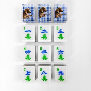 a collection of white tiles with various images and numbers on them, arranged in a grid-like pattern.