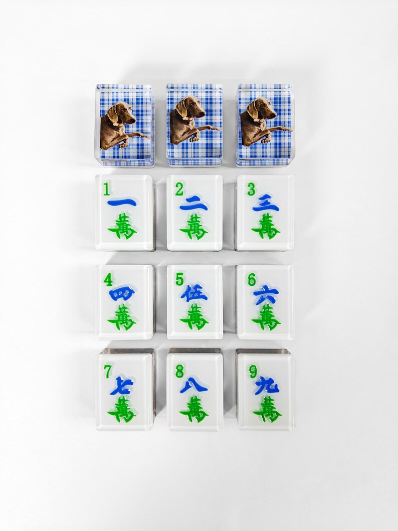 a collection of white tiles with various images and numbers on them, arranged in a grid-like pattern.