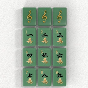 a collection of green tiles with gold musical notes and Chinese characters on them, arranged in a grid pattern.