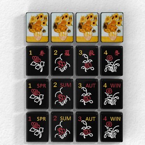 a collection of black tiles with various floral designs and numbers on them, arranged in a grid-like pattern.