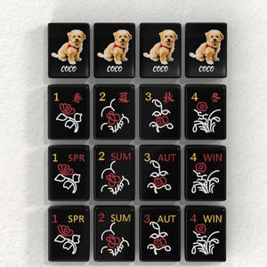 a collection of black tiles with various floral designs and text, including the word "Coco" and numbers 1 through 4.
