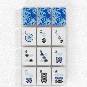 The image is a collage of nine tiles, each with a unique design and number. The tiles are arranged in a grid pattern, with each tile displaying a different design and number. The tiles are arranged in a vertical orientation, with the numbers 1 through 9 visible on each tile. The image does not contain any text, and the tiles are not described in detail.