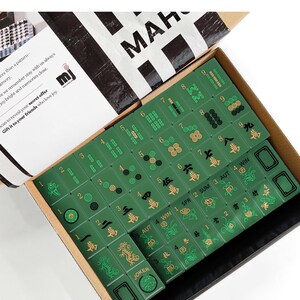 a box containing a set of mahjong tiles, with the tiles arranged in rows and columns.