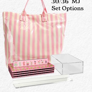 a pink and white striped tote bag, a clear plastic box, and a stack of pink and black boxes with various designs on them. The text above the image reads "30/36 MJ Set Options" and below the image, it states "Accessories vary by option selected."