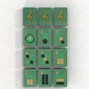 A collection of green tiles with musical notes and numbers on them, arranged in a grid pattern.