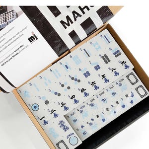 a set of mahjong tiles in an open box, with the text "Mahjong Set Only" visible.