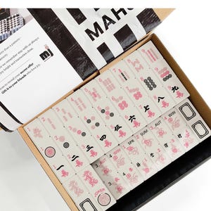 a set of mahjong tiles in an open box, with the text "Mahjong Set Only" visible.