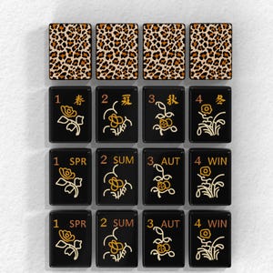 a collection of black tiles with various floral designs and numbers on them, arranged in a grid pattern.