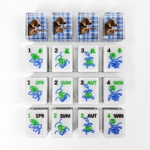 a collection of square tiles with various images and text on them, arranged in a grid-like pattern.