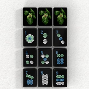 A collection of black tiles with various designs and numbers on them, arranged in a grid pattern.