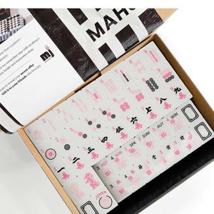 a set of mahjong tiles in an open box, with the text "Mahjong Set Only" visible.