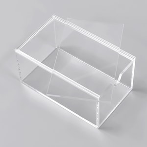 A clear, rectangular, and flat-lidded container made of plastic.