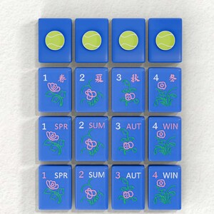 a collection of blue tiles with various floral designs and tennis ball images on them.