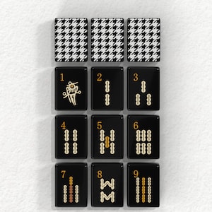 nine black tiles with various designs and numbers, arranged in a grid-like pattern.