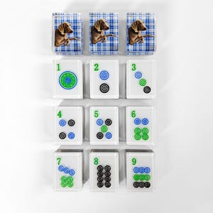 a collection of square tiles with various images and numbers on them, arranged in a grid-like pattern.