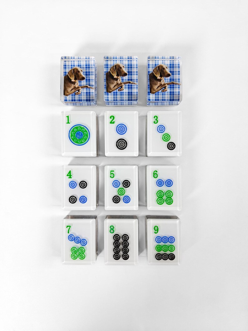 a collection of square tiles with various images and numbers on them, arranged in a grid-like pattern.