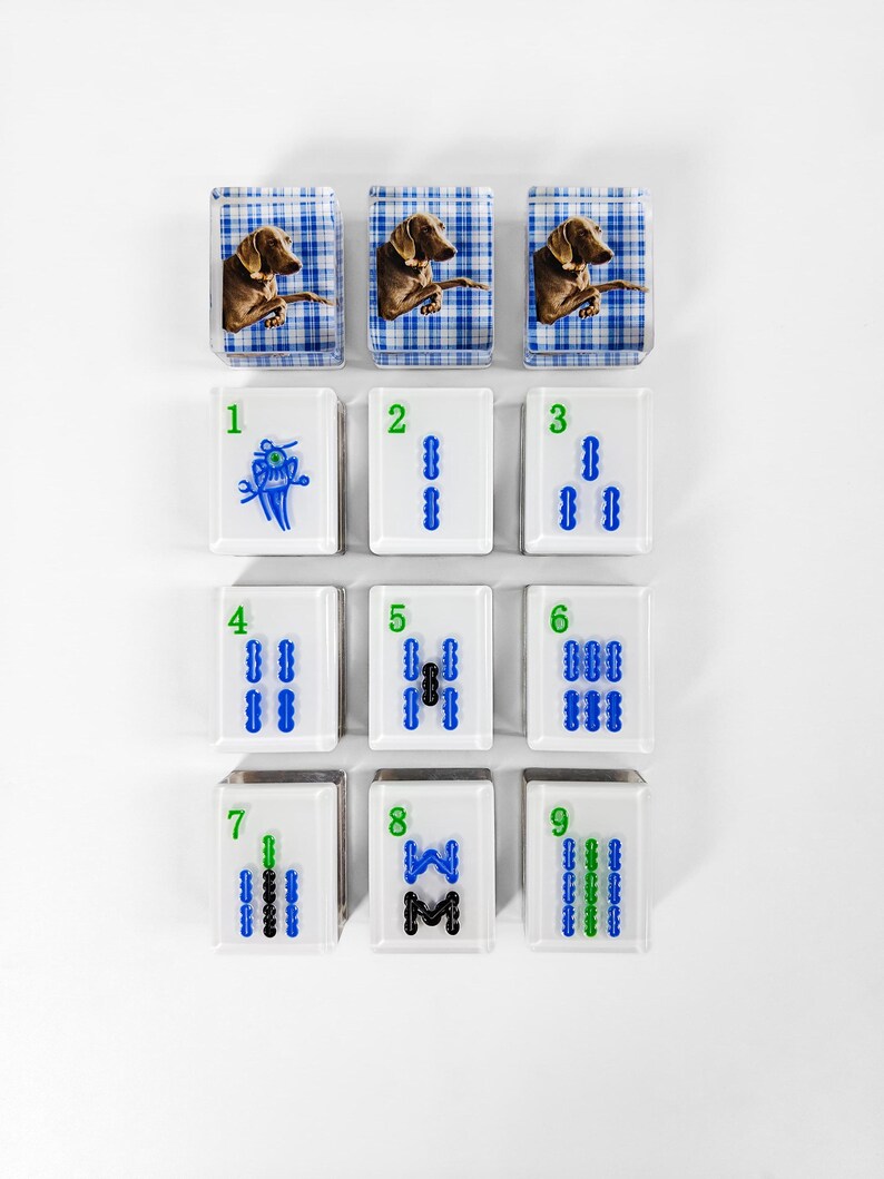 nine square tiles arranged in a 3x3 grid, each featuring a different animal and number combination.