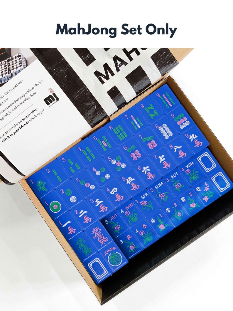 a box containing a set of mahjong tiles, with the tiles in various colors and designs.