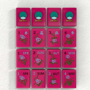 a collection of pink tiles with various floral designs and numbers, likely representing a game board or tiles for a game.