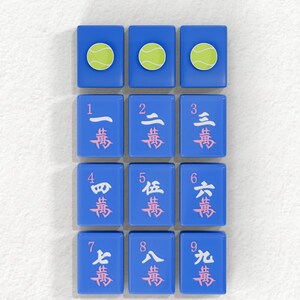 a collection of blue tiles with tennis balls and numbers on them, arranged in a grid pattern.