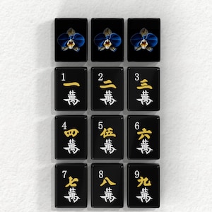a collection of black tiles with various characters and numbers on them, arranged in a grid pattern.