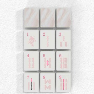 a grid of nine tiles, each with a unique design or pattern, arranged in a 3x3 grid. The tiles are white and have a pink or beige color scheme. The text "BAMBOOS TILES" is displayed above the tiles.