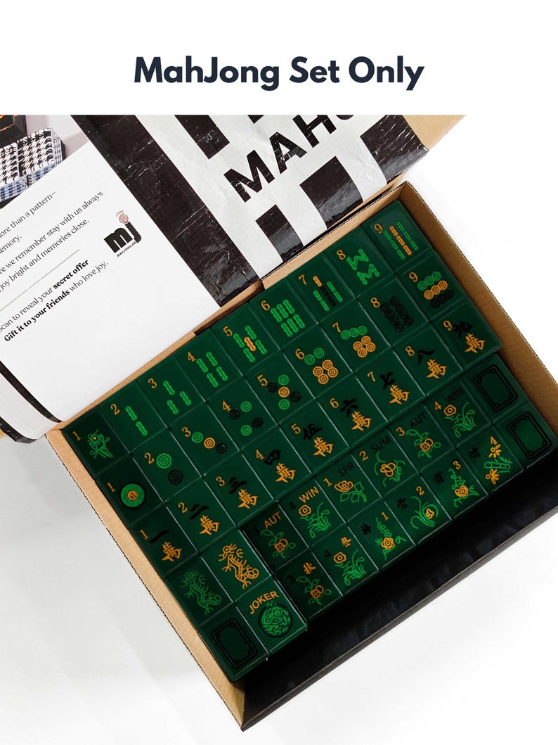 a box containing a set of mahjong tiles, with the box open to reveal the tiles inside.