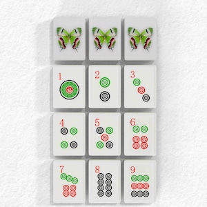 The image is a collage of 12 tiles, each featuring a different design or pattern, including butterflies, circles, and numbers.