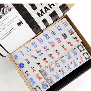 a set of mahjong tiles in an open box, with the text "Mahjong Set Only" visible.