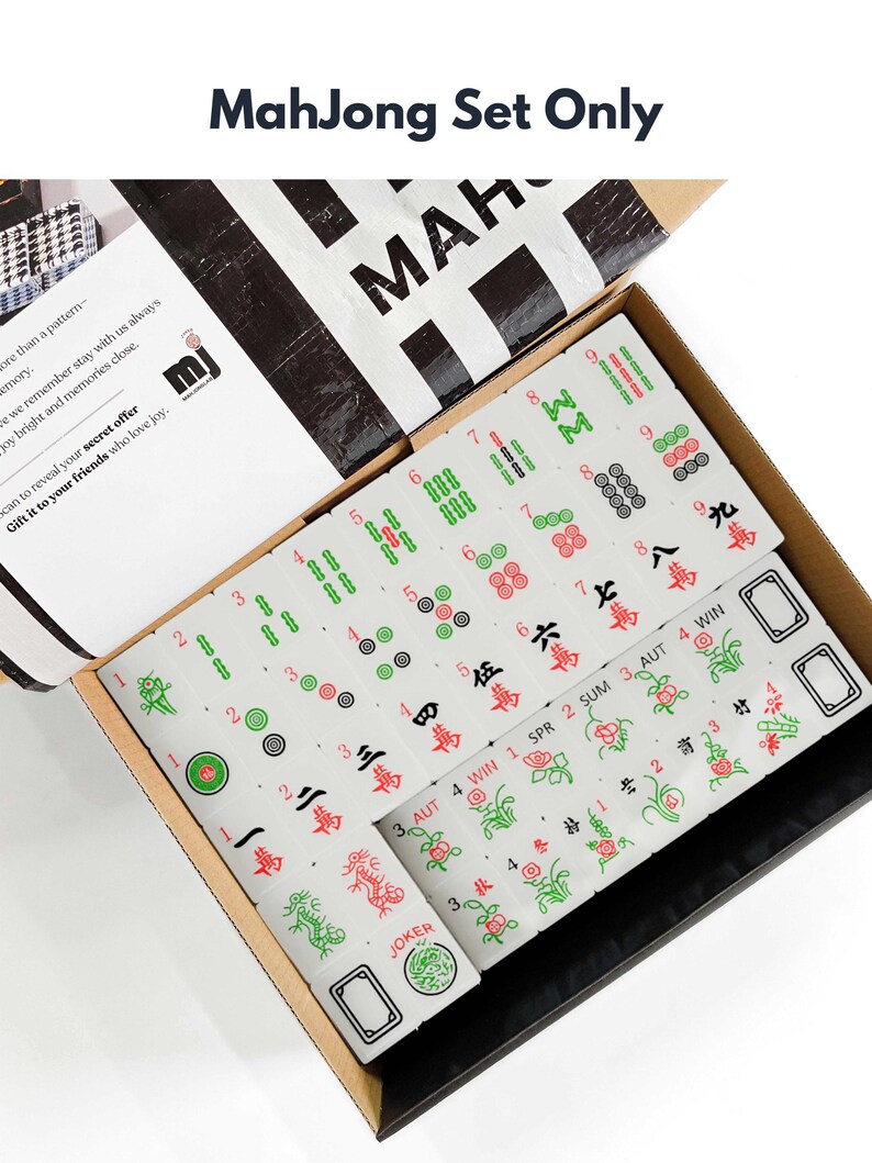 a box containing a Mah Jong set, which is a traditional Chinese tile-based game. The box is open, revealing the game components inside.