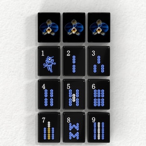 a grid of nine black tiles, each with a different design or symbol on it. The tiles are arranged in a 3x3 grid, and the text "BAMBOOS TILES" is displayed above the tiles.