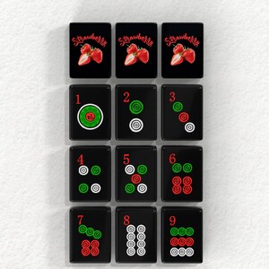 The image is a collage of 12 tiles, each featuring a different design or pattern, including images of strawberries and numbers.