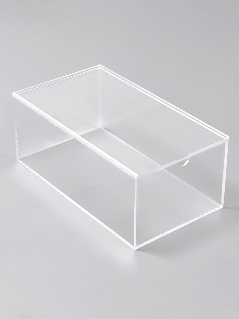 A clear, rectangular plastic container with a lid, sitting on a plain surface.