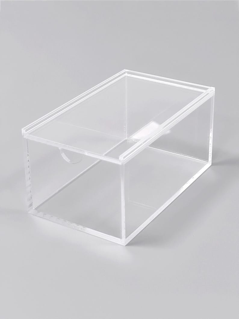 A clear, rectangular storage box with a transparent interior.