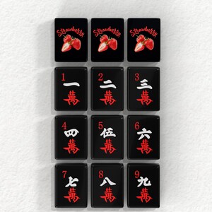 a collection of black tiles with red and white text and images, arranged in a grid pattern.