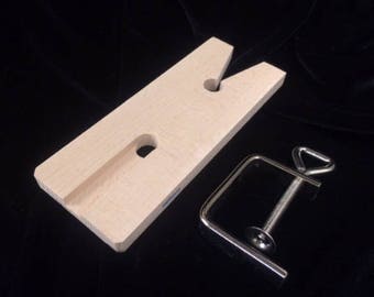May include: A wooden jewelry making tool with a V-shaped groove and two holes. A metal clamp is included.