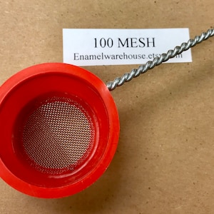 May include: A red plastic strainer with a 100 mesh screen. The strainer is attached to a twisted metal wire.