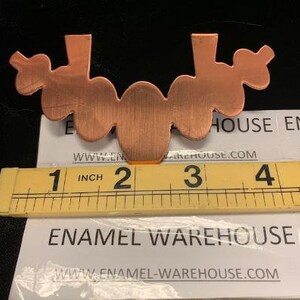 May include: Copper metal cutout of a scalloped edge design, measuring approximately 3 inches wide. The cutout is a decorative piece for crafting projects.